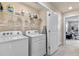 Bright laundry room with washer, dryer, and shelving at 14234 Lanikai Beach Dr, Orlando, FL 32827