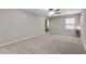 Spacious bedroom with carpeted floors and large window at 14234 Lanikai Beach Dr, Orlando, FL 32827