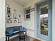 Front porch with a bench, wall decor, and a light blue door at 14234 Lanikai Beach Dr, Orlando, FL 32827