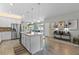 Open kitchen boasting a center island, white cabinets, and stylish pendant lights at 14234 Lanikai Beach Dr, Orlando, FL 32827