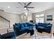Bright living room with ample seating and view into the kitchen at 14234 Lanikai Beach Dr, Orlando, FL 32827