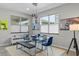 Modern dining room featuring a glass table and stylish pendant lights at 14234 Lanikai Beach Dr, Orlando, FL 32827