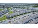Aerial view of a large community with many houses and a lake at 14234 Lanikai Beach Dr, Orlando, FL 32827
