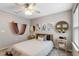Cozy bedroom with a queen bed, wall art, and ceiling fan at 14234 Lanikai Beach Dr, Orlando, FL 32827