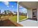 Covered patio with access to grassy backyard and neighboring homes at 3062 Bootlace Way, Saint Cloud, FL 34771