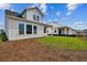 Two-story house with backyard and nearby construction at 3062 Bootlace Way, Saint Cloud, FL 34771