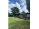 Ranch style home with dark exterior, covered porch, and well-manicured lawn at 118 5Th Jpv St, Winter Haven, FL 33880