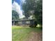 Side view of a charming ranch house with landscaping and a green lawn at 118 5Th Jpv St, Winter Haven, FL 33880