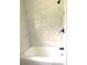 Clean bathroom with a shower/tub combo and marble-look tile at 118 5Th Jpv St, Winter Haven, FL 33880