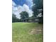 Front view of a ranch-style home with a large yard and mature trees at 118 5Th Jpv St, Winter Haven, FL 33880