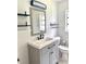 Bathroom features a vanity, toilet, and updated lighting at 118 5Th Jpv St, Winter Haven, FL 33880