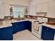 Updated kitchen with blue cabinets, white countertops, and modern appliances at 118 5Th Jpv St, Winter Haven, FL 33880