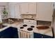 Updated kitchen with blue cabinets, white countertops, and modern appliances at 118 5Th Jpv St, Winter Haven, FL 33880