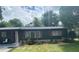 Ranch-style home with dark exterior, landscaping, and a spacious yard at 118 5Th Jpv St, Winter Haven, FL 33880