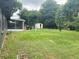 Large backyard with grassy area, shed, and screened patio at 118 5Th Jpv St, Winter Haven, FL 33880