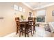 Bright dining nook with a wooden table and chairs near a window at 8830 Villa View Cir # 204, Orlando, FL 32821