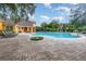 Inviting community pool with surrounding lounge chairs and patio at 8830 Villa View Cir # 204, Orlando, FL 32821