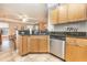Modern kitchen with wood cabinets, granite countertops, and stainless steel appliances at 8830 Villa View Cir # 204, Orlando, FL 32821