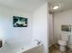 Bathroom with shower and tub, toilet, and decorative artwork at 1622 Tally Ho Dr, Lakeland, FL 33810