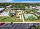 Drone view showing resort-style pool, tennis court, and putting green at 1622 Tally Ho Dr, Lakeland, FL 33810
