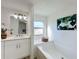 Bathroom with soaking tub, window, and decorative wall art at 1622 Tally Ho Dr, Lakeland, FL 33810