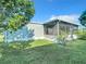 Landscaped backyard with large screened enclosure at 1622 Tally Ho Dr, Lakeland, FL 33810