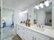 Double vanity bathroom with white cabinets and quartz countertop at 1622 Tally Ho Dr, Lakeland, FL 33810