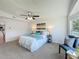 Main bedroom with ceiling fan, large windows, and seating area at 1622 Tally Ho Dr, Lakeland, FL 33810