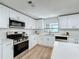 Updated kitchen featuring white cabinets, stainless steel appliances and a large island at 1622 Tally Ho Dr, Lakeland, FL 33810