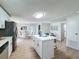 Modern kitchen with white cabinets, quartz countertops and a kitchen island at 1622 Tally Ho Dr, Lakeland, FL 33810