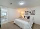 Bright bedroom with plush bedding and a view into the dining area at 1622 Tally Ho Dr, Lakeland, FL 33810
