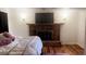 Main bedroom with fireplace and wood floors at 1015 Lake Emerald Dr, Orlando, FL 32806