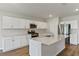 Modern kitchen with white cabinets, quartz countertops, and stainless steel appliances at 705 Ambleside Dr, Haines City, FL 33844