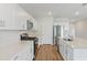 Modern kitchen with white cabinets, quartz countertops, and stainless steel appliances at 705 Ambleside Dr, Haines City, FL 33844