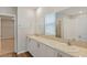 Double vanity bathroom with a large mirror and white cabinets at 705 Ambleside Dr, Haines City, FL 33844