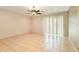 Large living room with tile floors, sliding glass doors and a ceiling fan at 15695 Sw 13Th Cir, Ocala, FL 34473