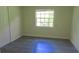 Bright bedroom featuring grey vinyl flooring and a window at 3225 Oakland N Rd, Lakeland, FL 33801