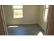 Simple bedroom with two windows and gray flooring at 3225 Oakland N Rd, Lakeland, FL 33801