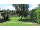 Landscaped backyard with mature trees and a fence at 3225 Oakland N Rd, Lakeland, FL 33801