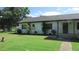Side view of a white brick ranch house at 3225 Oakland N Rd, Lakeland, FL 33801
