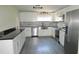 Modern kitchen with white cabinets, stainless steel appliances, and granite countertops at 3225 Oakland N Rd, Lakeland, FL 33801
