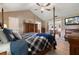 Main bedroom with large bed, access to patio, and ensuite bath at 105 Hainesport Dr, Lake Alfred, FL 33850