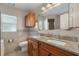 Bathroom with double vanity, granite countertop, and large mirror at 105 Hainesport Dr, Lake Alfred, FL 33850