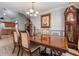 Formal dining room with hardwood floors, a large table, and a grandfather clock at 105 Hainesport Dr, Lake Alfred, FL 33850