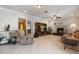 Bright living room with a fireplace, large TV, and exercise equipment at 105 Hainesport Dr, Lake Alfred, FL 33850