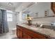 Bathroom with double vanity, granite countertop, and shower/tub at 105 Hainesport Dr, Lake Alfred, FL 33850