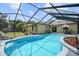 Inviting screened pool with a large patio and lush landscaping at 105 Hainesport Dr, Lake Alfred, FL 33850