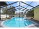Inviting kidney-shaped pool with a screened enclosure and comfortable seating area at 105 Hainesport Dr, Lake Alfred, FL 33850