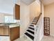 Indoor staircase with dark wood steps and white risers, located near the kitchen at 924 Timber Isle Dr, Orlando, FL 32828