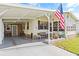 Exterior view of a manufactured home with a covered carport and landscaped lawn at 6505 Raintree Ne Ln, Winter Haven, FL 33881